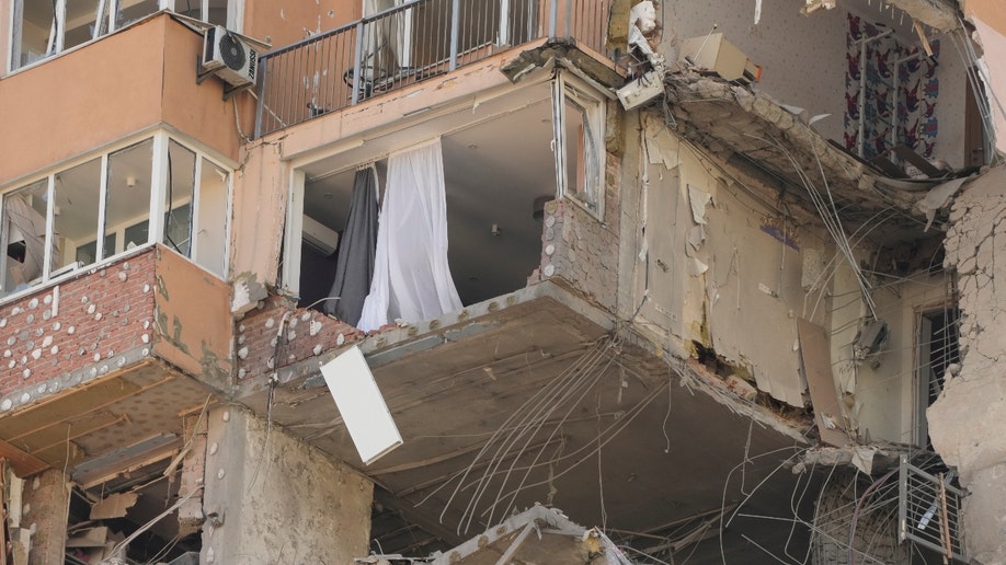 An apartment building damaged following a rocket attack on the city of Kyiv, Ukraine, Saturday, Feb. 26, 2022. Russian troops stormed toward Ukraine's capital Saturday, and street fighting broke out as city officials urged residents to take shelter. (AP Photo/Efrem Lukatsky)