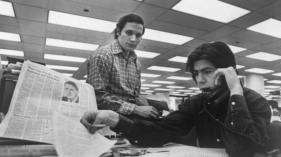 (Original Caption) Bob Woodward (left) and Carl Bernstein, Washington Post staff writers who have been investigating the Watergate case, at their desk in the Post.