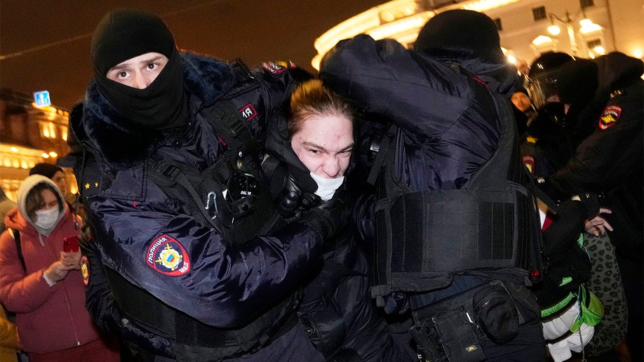 Police detaining Russian protestors