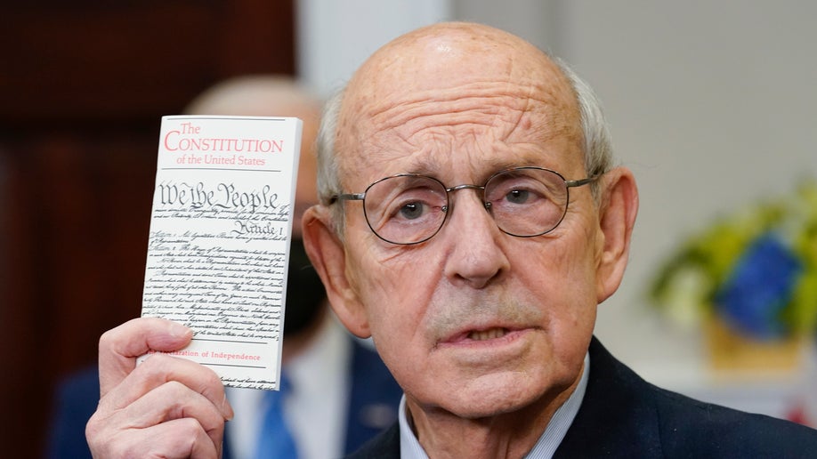 Supreme Court Associate Justice Stephen Breyer holds US Constitution