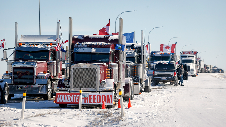 A truck convoy of anti-COVID-19 vaccine mandate demonstrators continue to block the highway at the busy U.S. border crossing in Coutts, Alberta, Wednesday, Feb. 2, 2022.