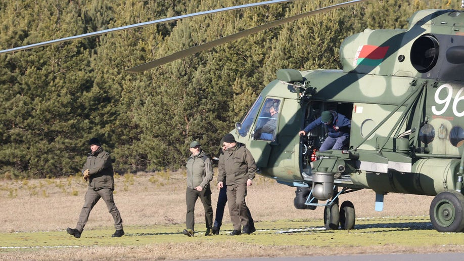 Members of the Ukrainian delegation disembark from a helicopter as they arrive for talks with Russian representatives in the Gomel region, Belarus February 28, 2022. Sergei Kholodilin/BelTA/Handout via REUTERS