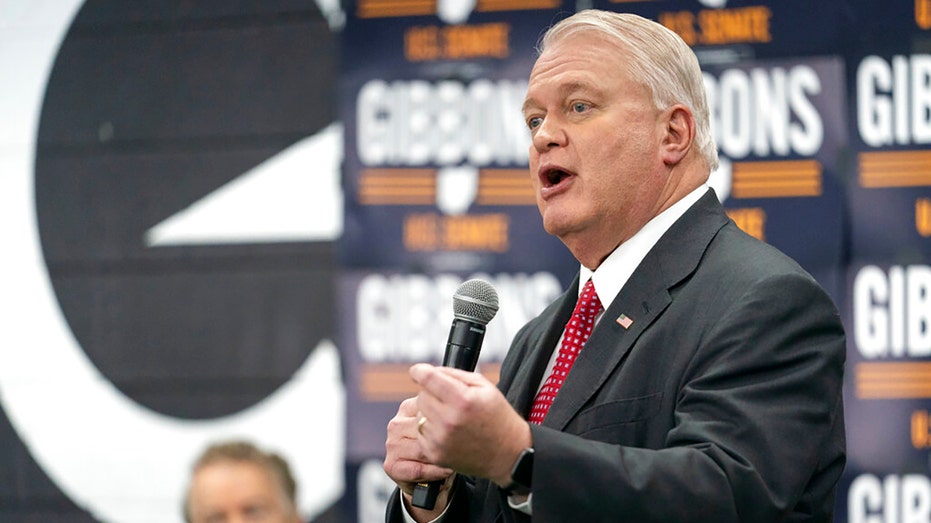 Mike Gibbons, a Republican Senate candidate for Ohio, speaks to supporters as Sen. Rand Paul, R-Ky., looks on during a campaign rally in Maineville, Ohio, Friday, Jan. 14, 2022.