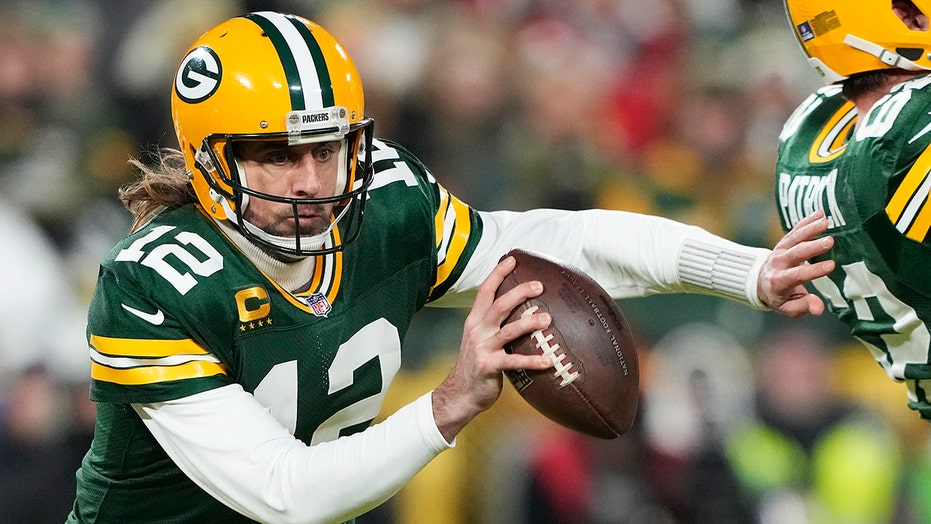 Aaron Rodgers avoids a pass rush to extend a play.