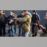 Civilian Members of a territorial defence unit fit their weapons to repel the Russian attacking forces in Kyiv, Ukraine, Saturday, Feb. 26, 2022. Russian troops stormed toward Ukraine's capital Saturday, and street fighting broke out as city officials urged residents to take shelter.