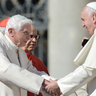 Pope Benedict and Pope Francis hold hands