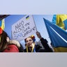 Demonstrators during a protest against the Russian invasion of Ukraine outside the White House in Washington, D.C., U.S., on Sunday, Feb. 27, 2022. Russia's plans for Ukraine face rapidly rising costs due to delays caused by tougher-than-expected resistance from forces on the ground, even as its military retains overwhelming advantages.