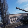 A Ukrainian tank moves Thursday following Russia's military operation in the town of Chuhuiv. Videos posted to social media show a tank running over a civilian vehicle from several vantage points. 