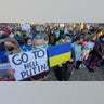 A participant holds a placard reading "Go to hell Putin" during a demonstration in Mint Square against the Russian invasion of Ukraine. Russian troops launched the expected attack on Ukraine and entered the capital.
