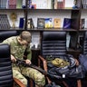 A civilian volunteer fixes his gun at a Territorial Defence unit registration office on February 26, 2022 in Kyiv, Ukraine. Explosions and gunfire were reported around Kyiv on the second night of Russia's invasion of Ukraine, which has killed scores and prompted widespread condemnation from US and European leaders.