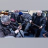 Civilian volunteers check their guns at a Territorial Defence unit registration office on February 26, 2022 in Kyiv, Ukraine. Explosions and gunfire were reported around Kyiv on the second night of Russia's invasion of Ukraine, which has killed scores and prompted widespread condemnation from US and European leaders.