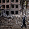 A man walks in front of a destroyed building after a Russian missile attack in the town of  Vasylkiv, near Kyiv, on February 27, 2022.