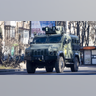 An armored vehicle drives along in Zhuliany neighborhood of Kyiv during Russia's invasion of Ukraine