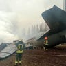 Rescuers work at the crash site of the Ukrainian Armed Forces' Antonov aircraft, which, according to the State Emergency Service, was shot down in Kyiv region, Ukraine, in this handout picture released February 24, 2022. Press service of the Ukrainian State Emergency Service/Handout via REUTERS 