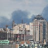 Smoke rising after shelling on the outskirts of the city is pictured from central Kyiv, Ukraine February 27, 2022. REUTERS/Irakli Gedenidze