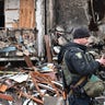 A police officer stands guard at a damaged residential building at Koshytsa Street, a suburb of the Ukrainian capital Kyiv, where a military shell allegedly hit, on February 25, 2022. - Invading Russian forces pressed deep into Ukraine as deadly battles reached the outskirts of Kyiv, with explosions heard in the capital early Friday that the besieged government described as "horrific rocket strikes". The blasts in Kyiv set off a second day of violence after Russian President Vladimir Putin defied Western warnings to unleash a full-scale ground invasion and air assault that quickly claimed dozens of lives and displaced at least 100,000 people. (Photo by GENYA SAVILOV / AFP) (Photo by GENYA SAVILOV/AFP via Getty Images)