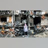 On 25 February 2022 in Kyiv, Ukraine, a girl looks at the crater left by an explosion in front of an apartment building which was heavily damaged during ongoing military operations.
