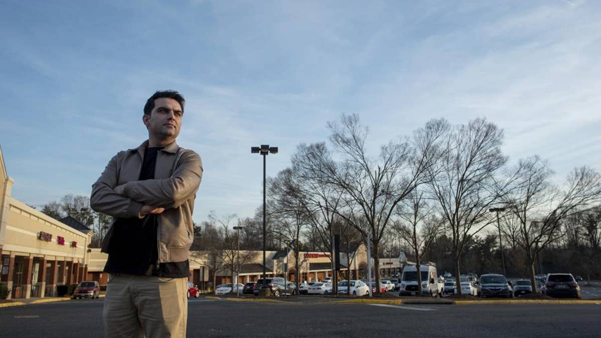 Afghan refugee Ahmad Saeed Totakhail poses for a photograph at a shopping center near his home in Dale City, Va.