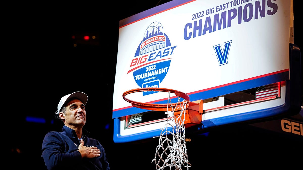 Villanova head coach Jay Wright gestures to supporters while cutting down the net after the final of the Big East conference tournament against Creighton, Saturday, March 12, 2022, in New York.