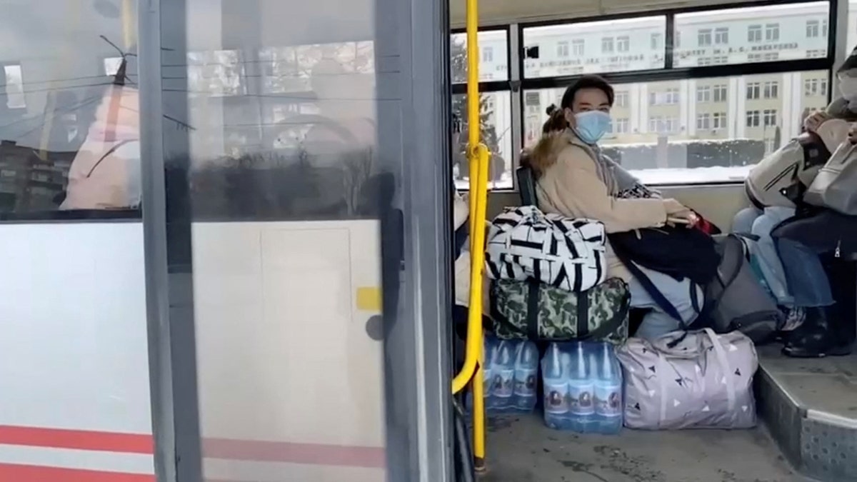 Civilians sit inside a bus with bottled water and belongings during evacuations, amid the Russian invasion of Ukraine, out of Sumy, March 8, 2022 in this still image obtained from handout video. Deputy Head for President's Office, Ukraine/Handout via REUTERS THIS IMAGE HAS BEEN SUPPLIED BY A THIRD PARTY. MANDATORY CREDIT. NO RESALES. NO ARCHIVES