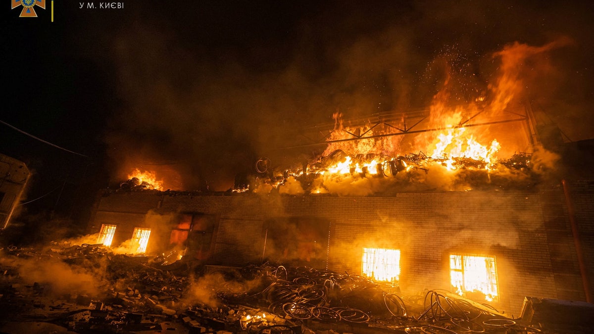 Rescuers work at a site of buildings damaged by a shelling in Kyiv