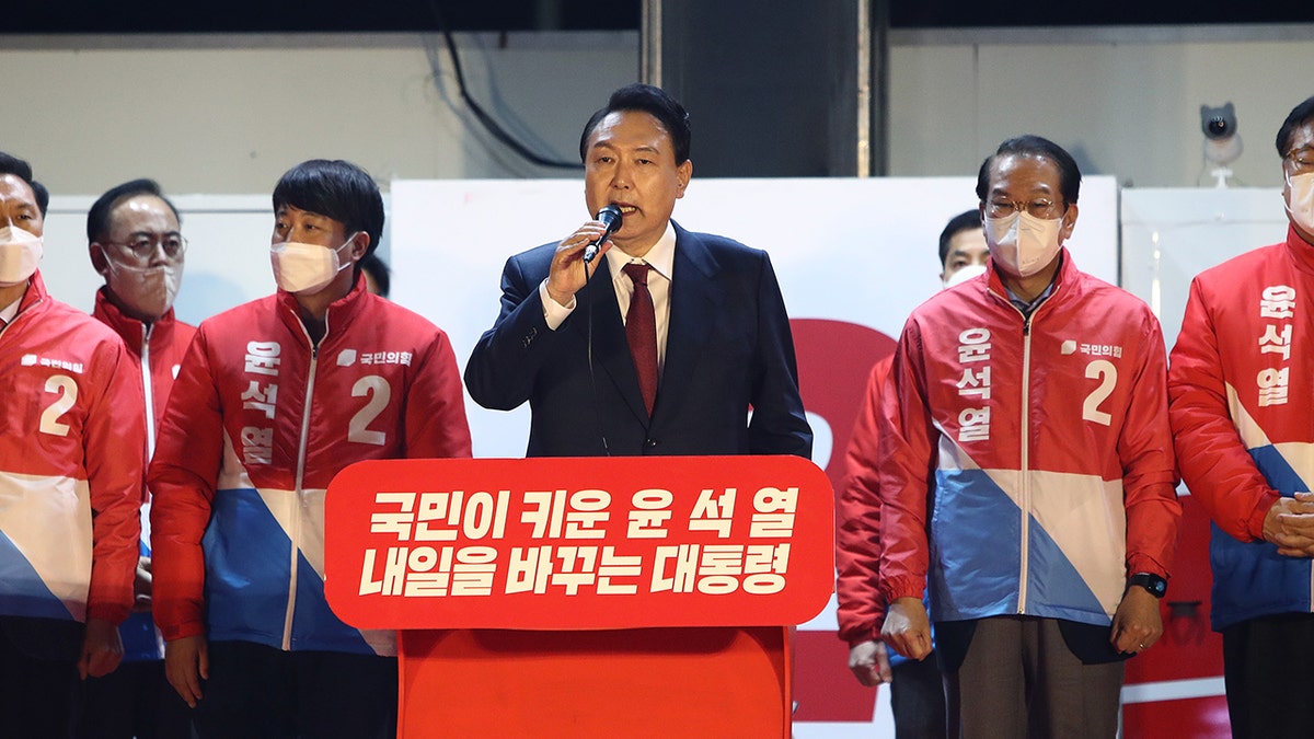 South Korean President-elect Yoon Suk-yeol of the main opposition People Power Party celebrating with supporters at the party's headquarters on March 10 in Seoul.