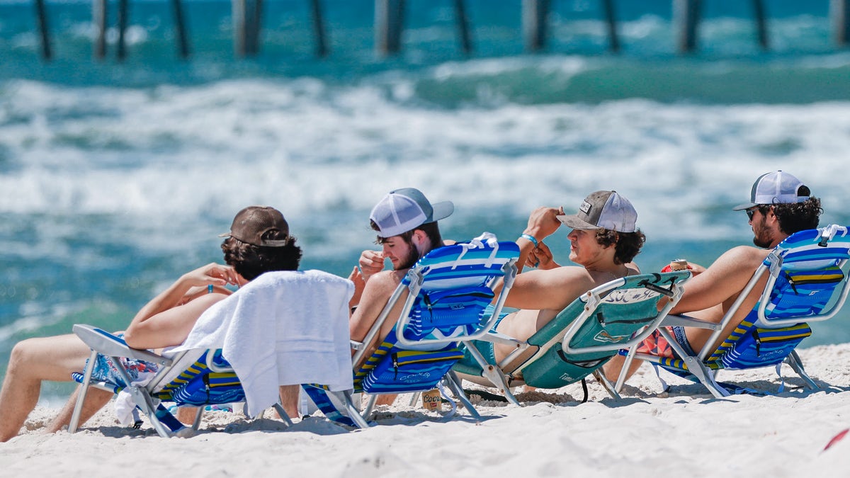 Spring breakers relax in Panama City Beach, Florida, on March 26, 2022.