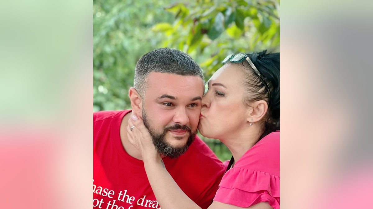 Irena Laura Yoder kisses her son TJ, 35, in Ukraine, September 2021.