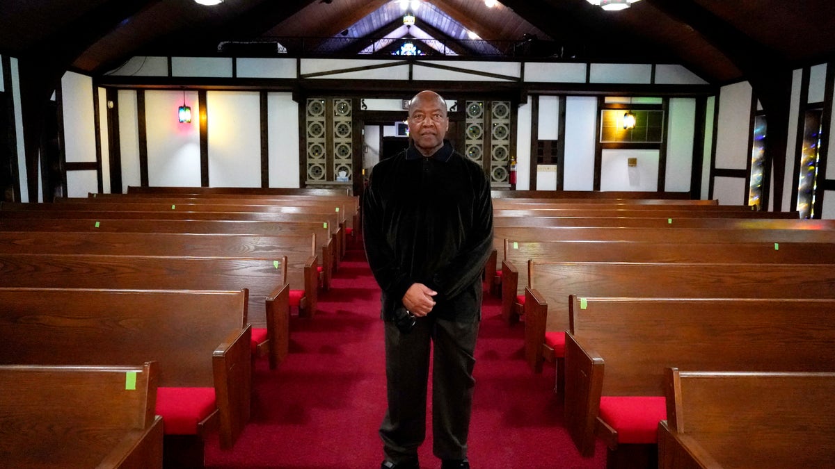 Rev. David Bigsby poses for a photo at his church in Lansing, Ill.