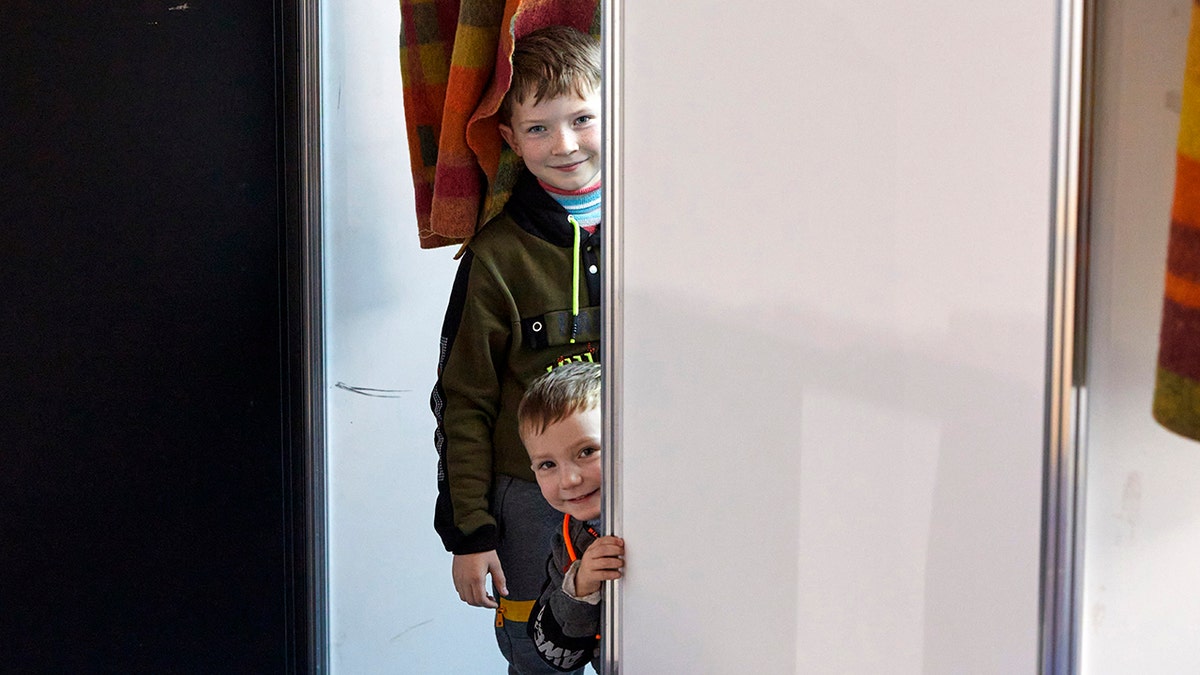 Children from Ukraine smile at a facility for refugees in Chisinau, Moldova, Monday, Feb. 28, 2022. 