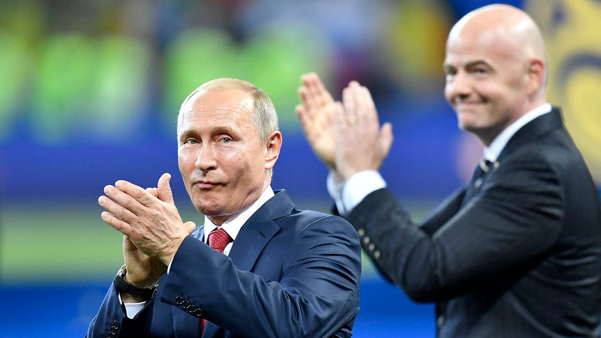 Russian President Vladimir Putin, left, applauds beside FIFA President Gianni Infantino at the end of the 2018 World Cup final soccer match between France and Croatia in the Luzhniki Stadium in Moscow, Russia, July 15, 2018. 