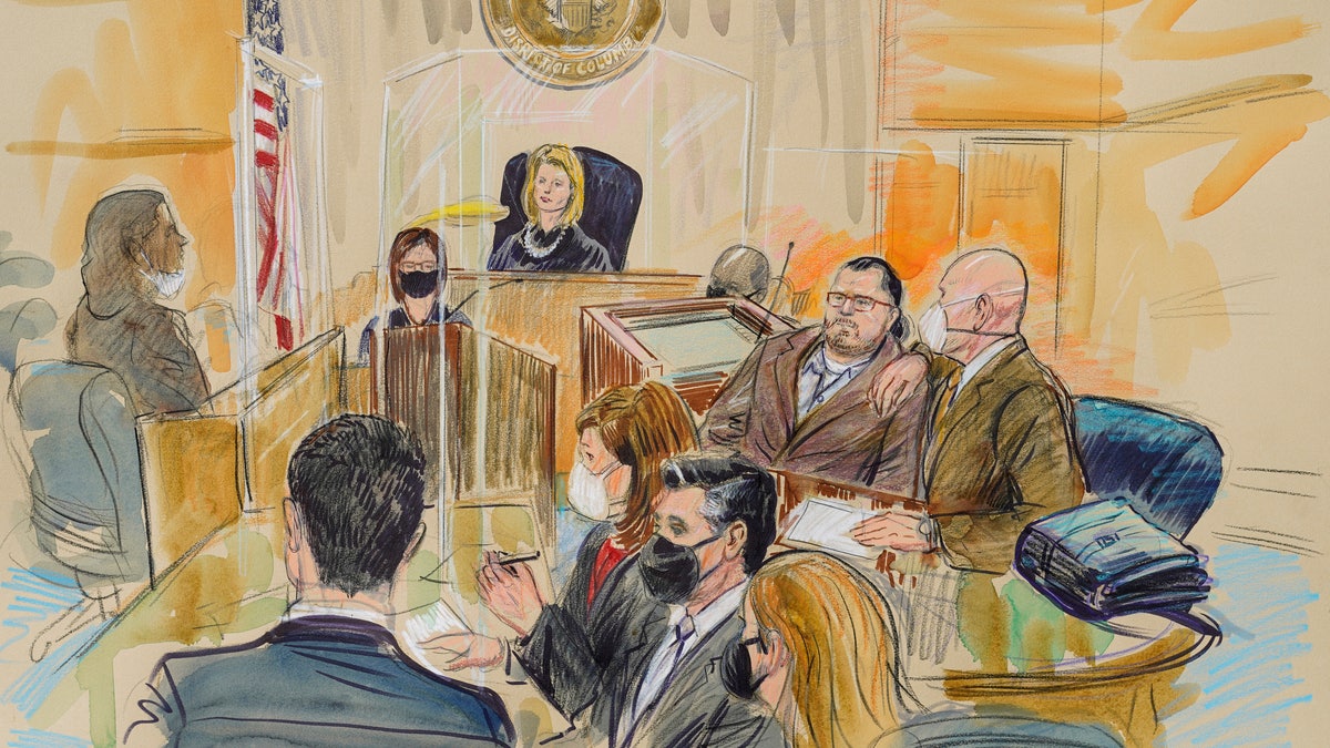 This artist sketch depicts Judge Dabney Friedrich looking out from the bench during jury selection for Guy Wesley Reffitt, joined by his lawyer William Welch, top right, in Federal Court, in Washington, Monday, Feb. 28, 2022.