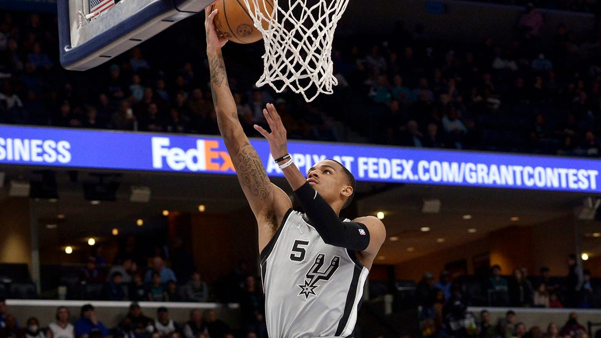 San Antonio Spurs guard Dejounte Murray shoots a layup during the first half of the team's NBA basketball game against the Memphis Grizzlies on Monday, Feb. 28, 2022, in Memphis, Tenn.