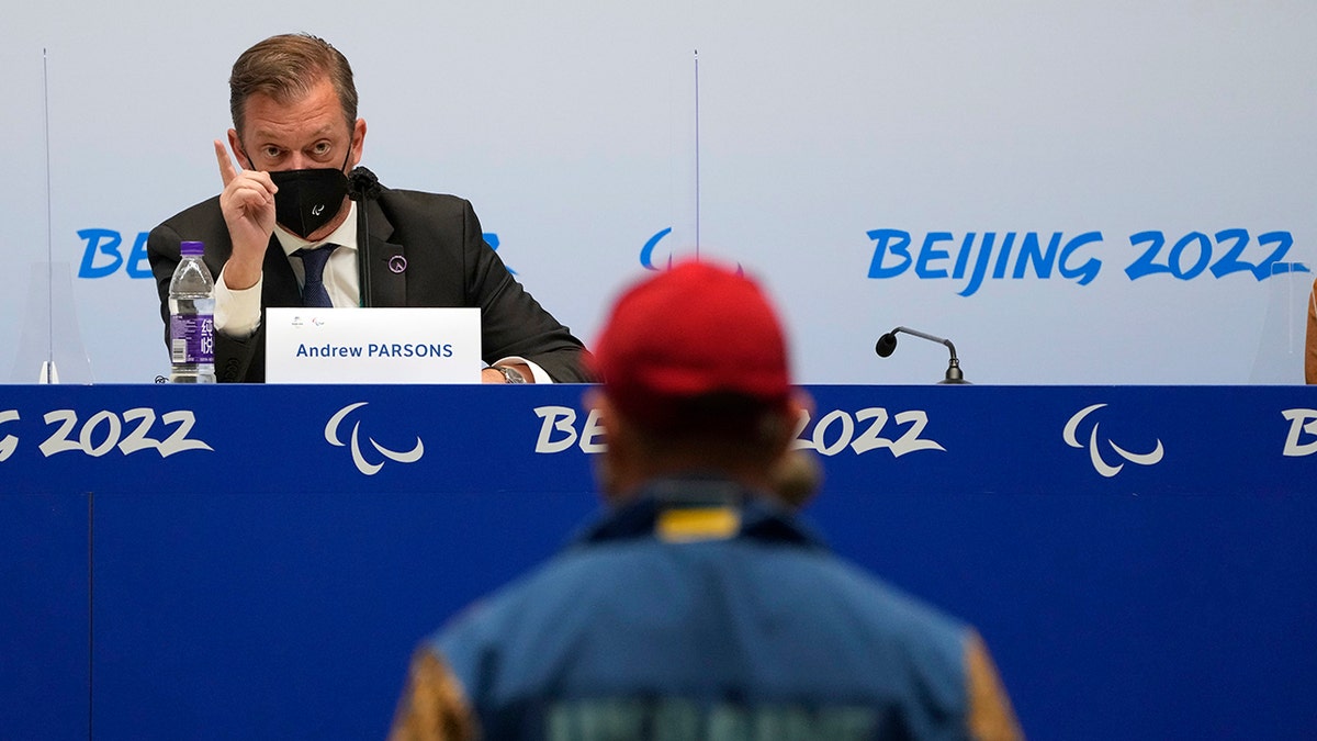 International Paralympic Committee (IPC) President Andrew Parsons speaks to a journalist from Ukraine during a press conference at the 2022 Winter Paralympics in Beijing, Wednesday, March 2, 2022.