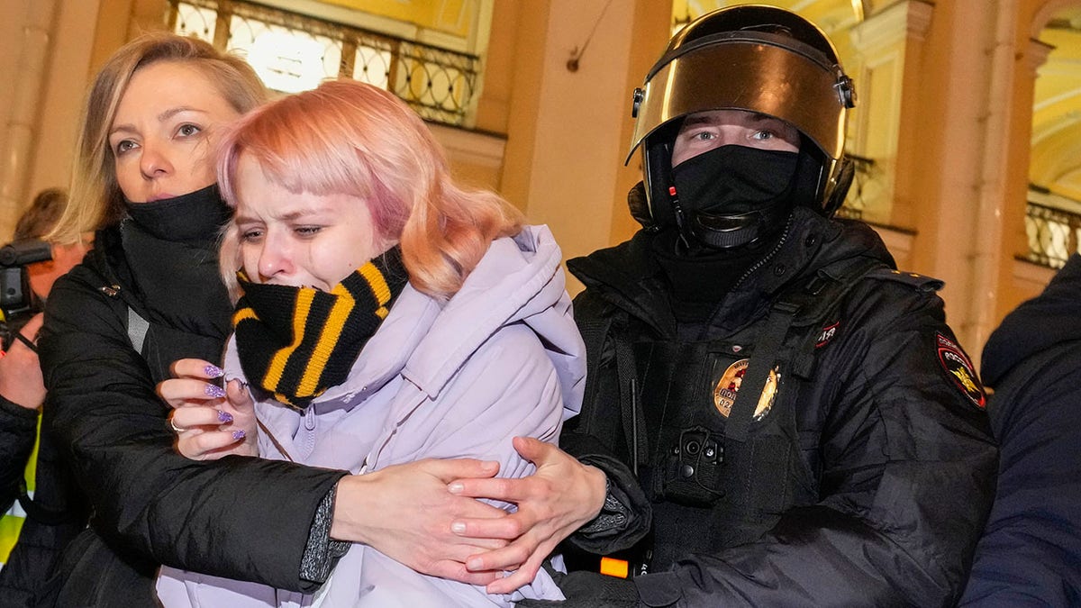 A Russian police officer, right, detains a demonstrator during an action against Russia's attack on Ukraine in St. Petersburg, Russia, Wednesday, March 2, 2022. 