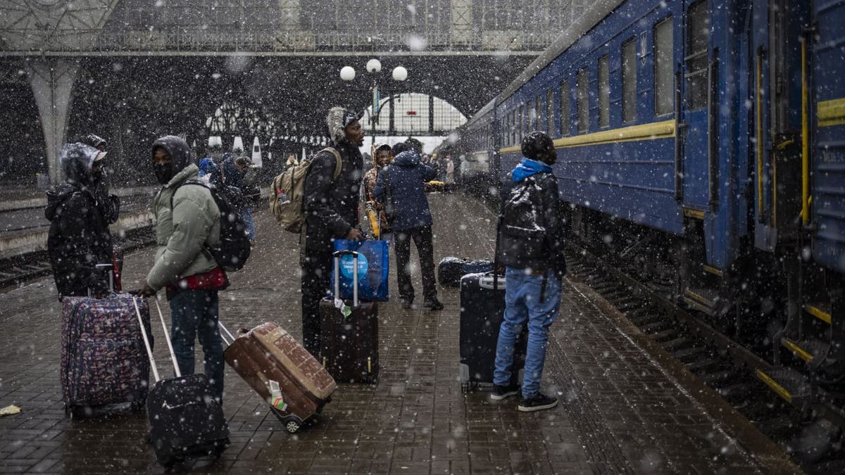 Nigerian students wait at Lviv train station in Ukraine