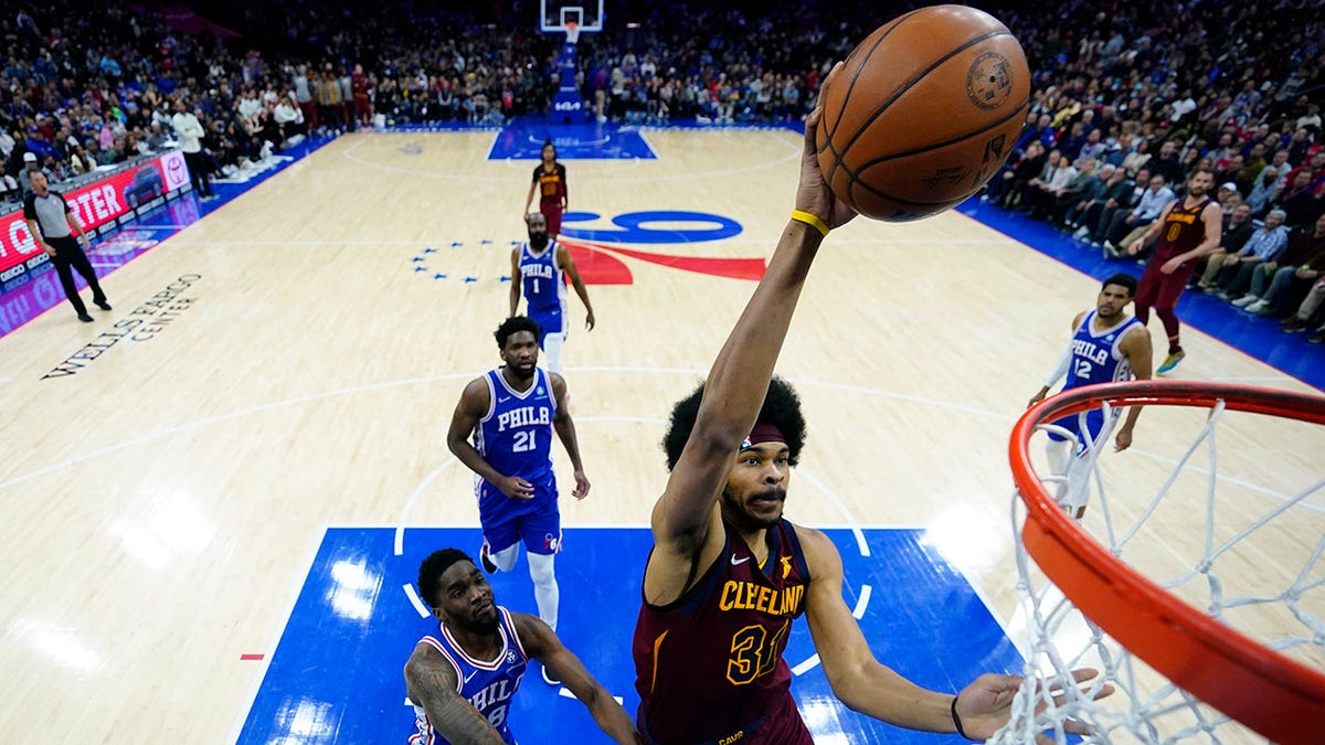 Cleveland Cavaliers' Jarrett Allen (31) goes up for a dunk past Philadelphia 76ers' Shake Milton (18) during the second half of an NBA basketball game, Friday, March 4, 2022, in Philadelphia.