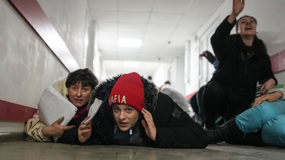 People lie on the floor of a hospital during shelling by Russian forces in Mariupol, Ukraine, Friday, March 4, 2022.