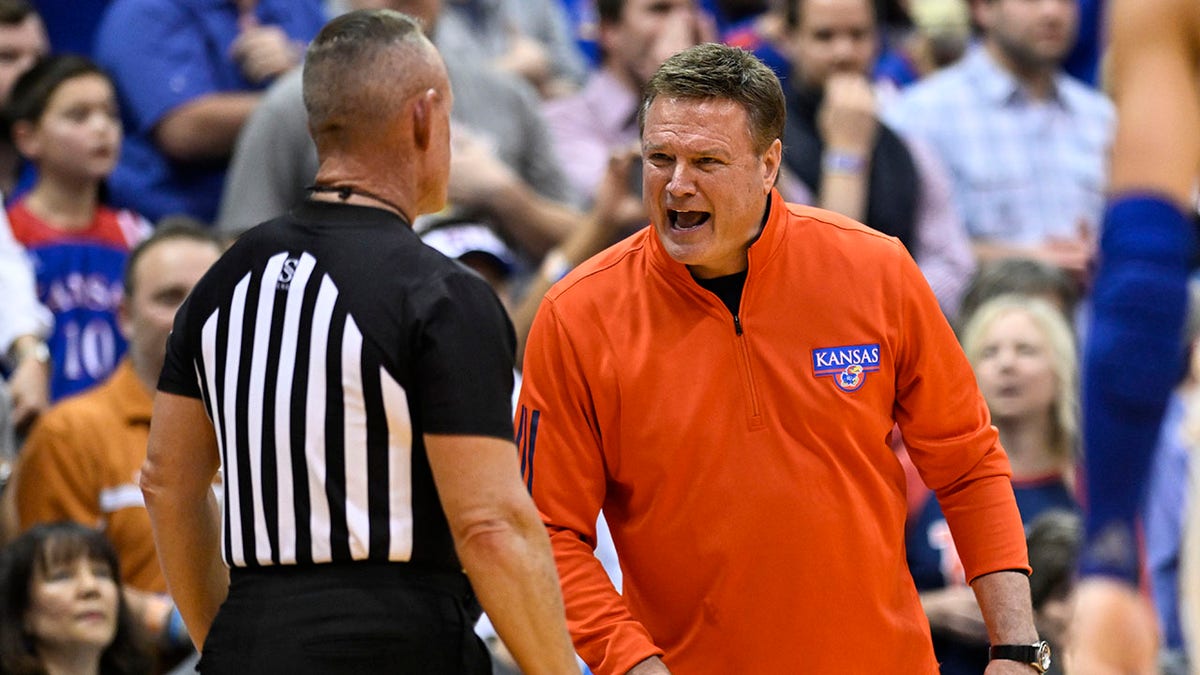 Kansas head coach Bill Self, right, argues a call with an official during the second half of an NCAA college basketball game against Texas in Lawrence, Kan., Saturday, March 5, 2022.