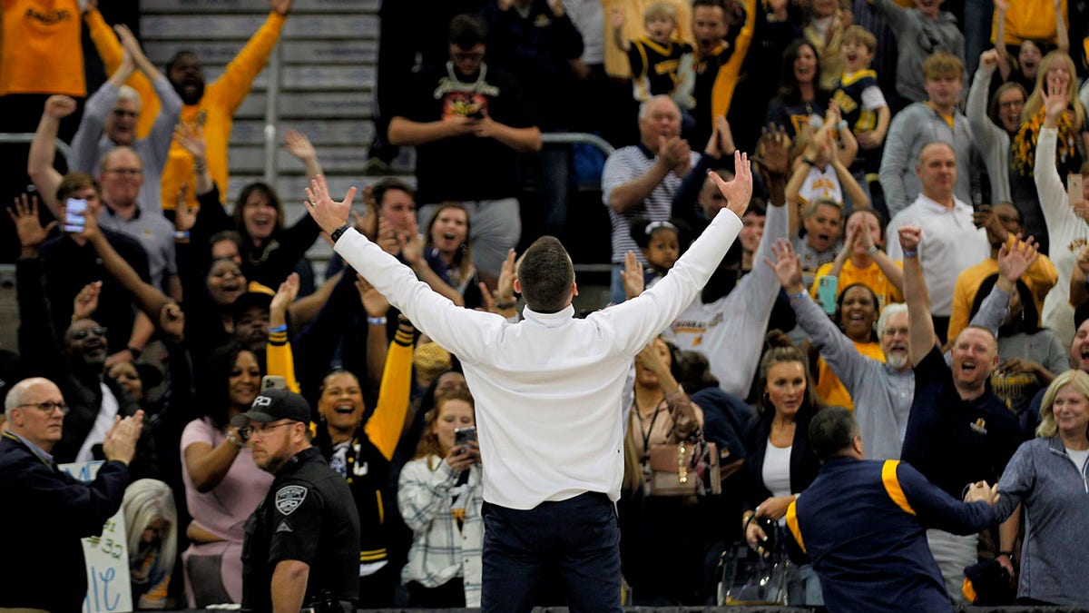 Murray State men's basketball coach Matt McMahon gestures to the crowd after the team's win over Morehead State in an NCAA college basketball game for the championship of the Ohio Valley Conference men's tournament Saturday, March 5, 2022, in Evansville, Ind.