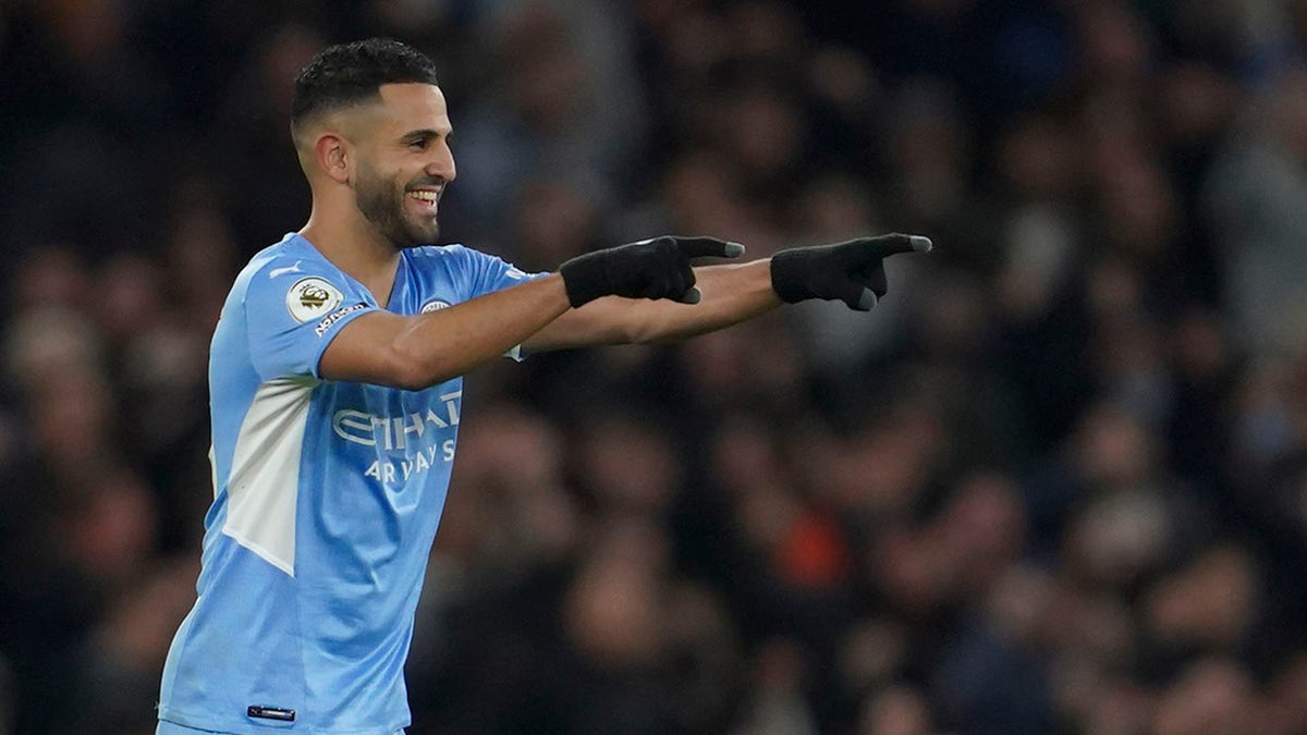 Manchester City's Riyad Mahrez celebrates after scoring his side's fourth goal during the English Premier League soccer match between Manchester City and Manchester United, at the Etihad stadium in Manchester, England, Sunday, March 6, 2022.