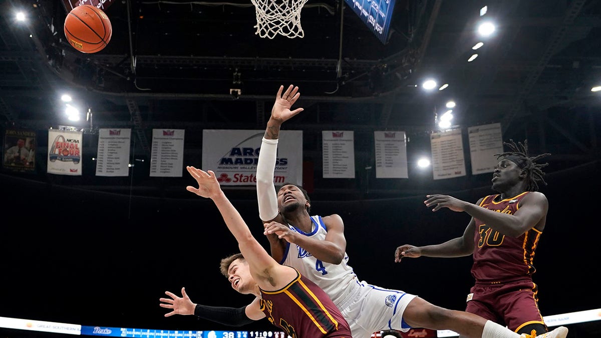 Drake's ShanQuan Hemphill, center, loses control of the ball as Loyola of Chicago's Braden Norris, left, and Aher Uguak (30) defend during the second half of an NCAA college basketball game in the championship of the Missouri Valley Conference tournament Sunday, March 6, 2022, in St. Louis.