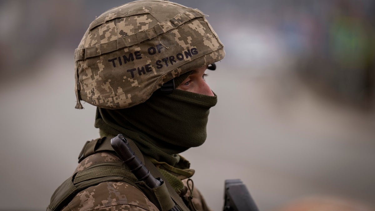 Ukrainian soldier with helmet and rifle