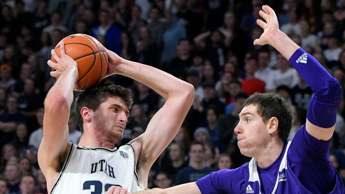 FILE - Utah State center Trevin Dorius (32) looks to shoot the ball as then-Weber State forward Dima Zdor, right,  defends during the second half of an NCAA college basketball game Friday, Nov. 8, 2019, in Logan, Utah. Zdor now plays for Grand Canyon. Ukrainians playing college basketball in the United States have tried to keep up their routines as Russia invades their home country. One of a handful of Ukrainians playing college basketball in the United States, Zdor can only watch from afar as Russian troops roll through his home country, hoping his family and friends remain safe.