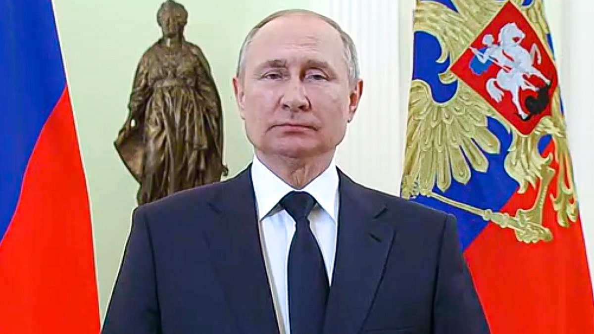In this handout photo made from video released by the Russian Presidential Press Service, Russian President Vladimir Putin speaks to celebrate International Women's Day, in Moscow, Russia, Tuesday, March 8, 2022. (Russian Presidential Press Service via AP)
