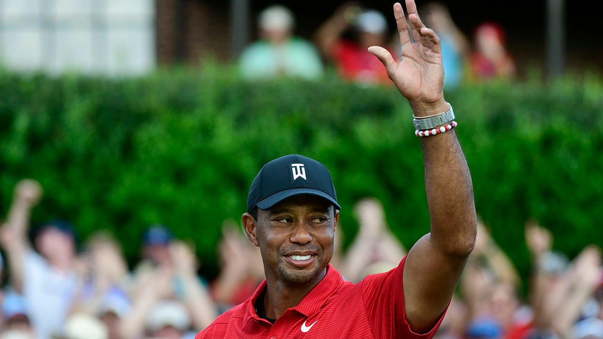 FILE - Tiger Woods celebrates on the 18th green after wining the Tour Championship golf tournament Sunday, Sept. 23, 2018, in Atlanta. Woods will be the star attraction in the World Golf Hall of Fame induction ceremony Wednesday, March 9, 2022.
