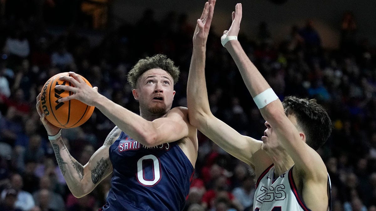 Saint Mary's Logan Johnson (0) shoots against Gonzaga's Chet Holmgren (34) during the second half of an NCAA college basketball championship game at the West Coast Conference tournament Tuesday, March 8, 2022, in Las Vegas.