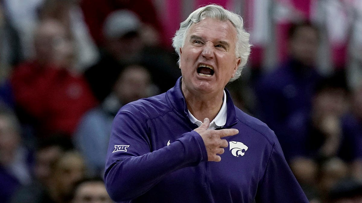 Kansas State coach Bruce Webber talks to players during the first half of the team's NCAA college basketball game against West Virginia in the first round of the Big 12 Conference tournament in Kansas City, Mo., Wednesday, March 9, 2022.