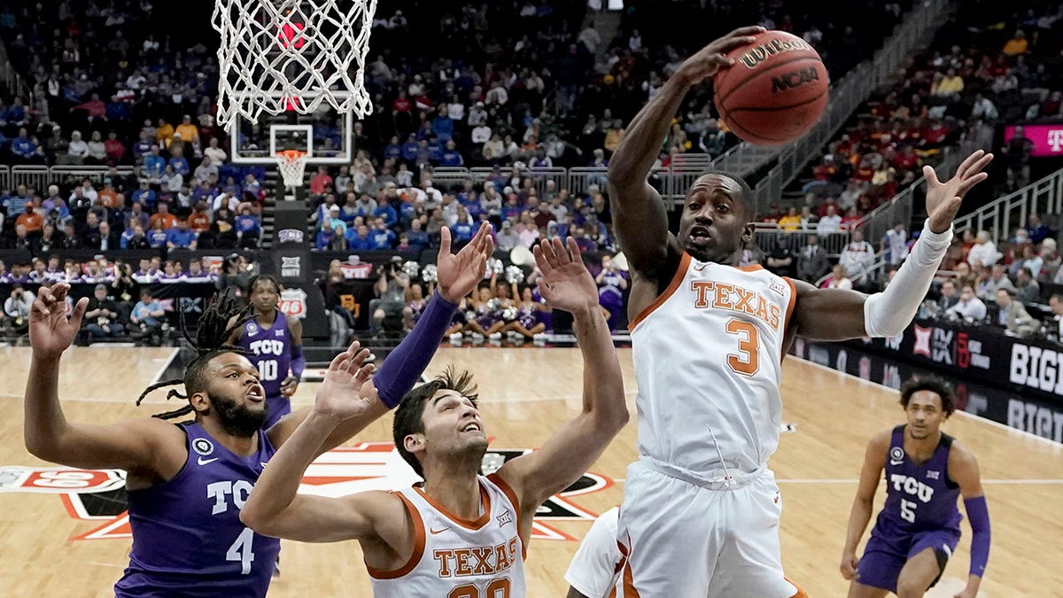 Texas guard Courtney Ramey (3) gets a rebound during the first half of an NCAA college basketball game against TCU in the quarterfinal round of the Big 12 Conference tournament in Kansas City, Mo., Thursday, March 10, 2022.