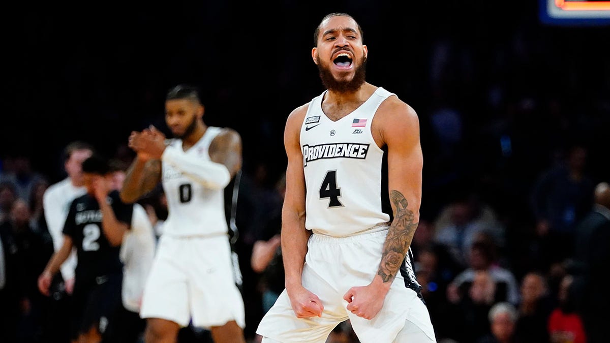 Providence's Jared Bynum (4) and Nate Watson (0) celebrate after an NCAA college basketball game against Butler at the Big East conference basketball tournament on Thursday, March 10, 2022, in New York. Providence won 65-61.